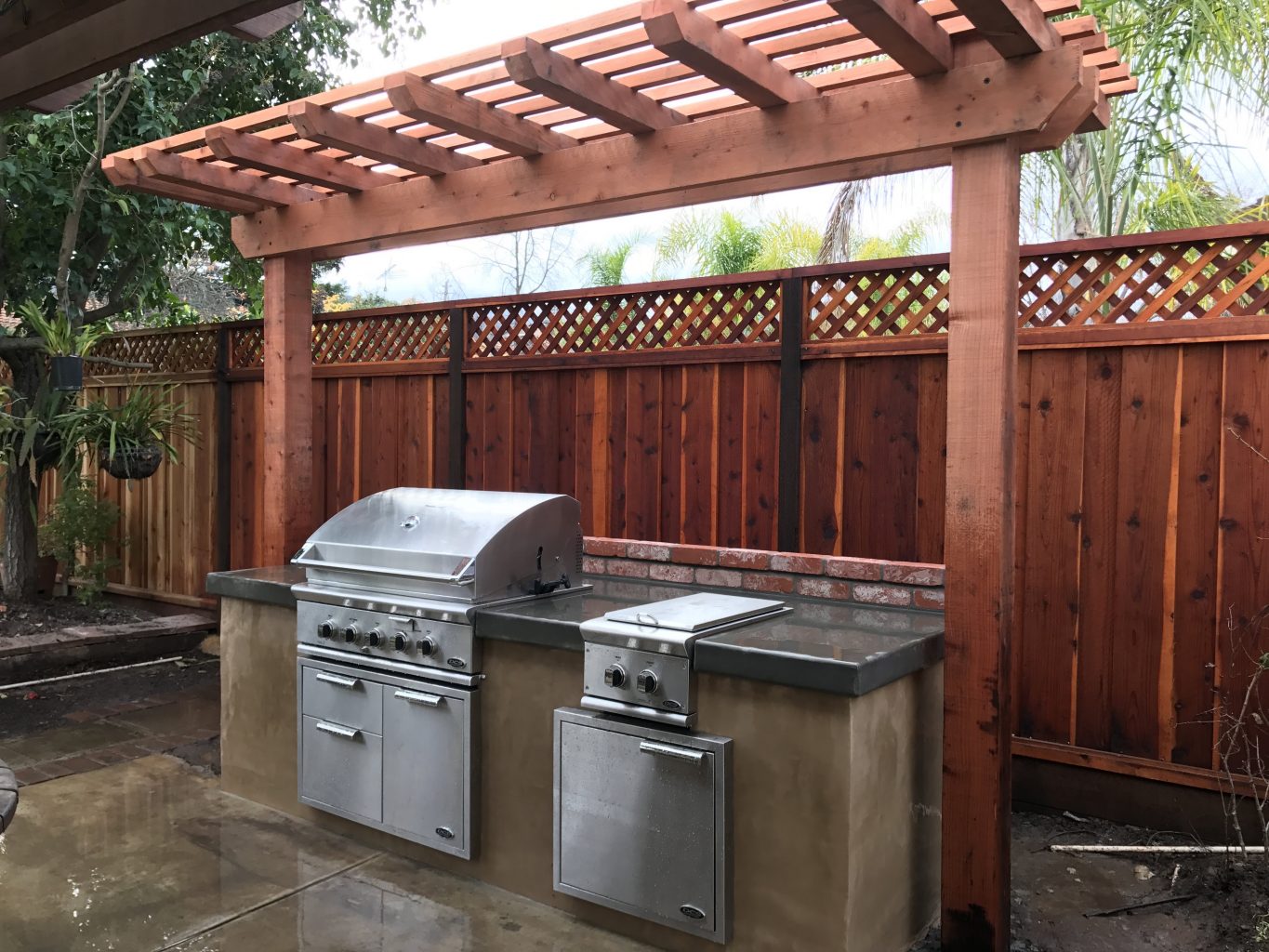 stucco face bbq with concrete counter top and brick backsplash