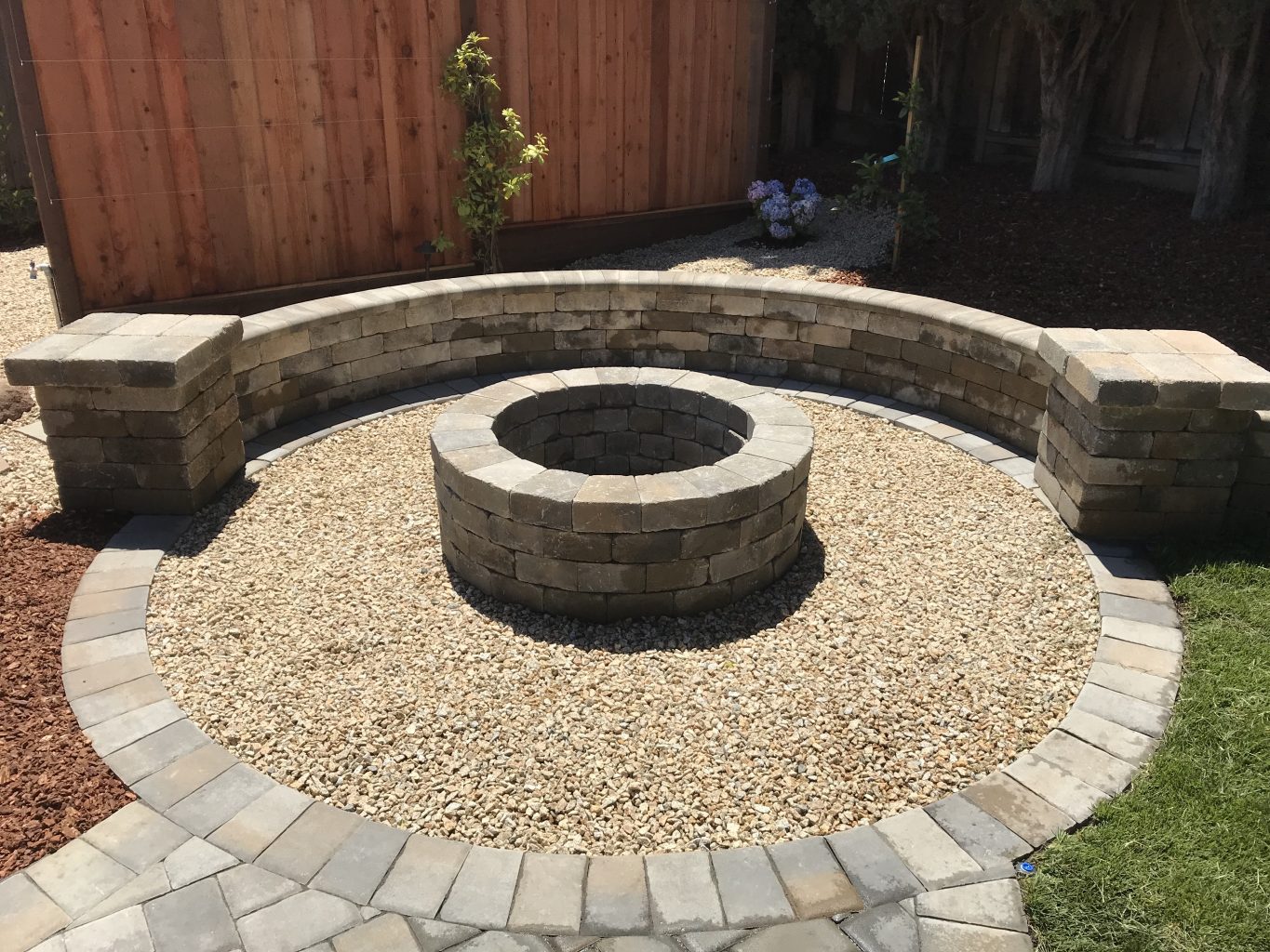 roman stone paver fire pit and seat wall